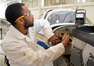 A student works on a plane at CT Aero Tech in Hartford.