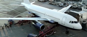 People loading cargo onto airplane